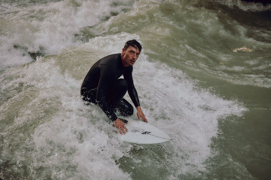 River surfing at the Eisbach in Munich River Surfer Sebastian Kuhn at the Eisbach in Munich