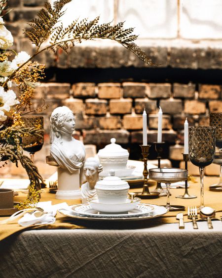 A table set with KPM porcelain and decorated with flowers and candles
