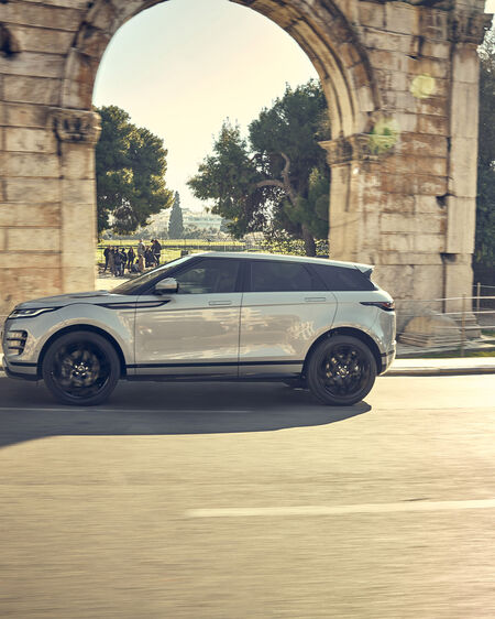 Range Rover Evoque drives past a historic archway in Athens