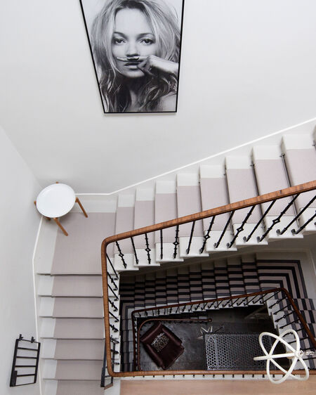 Staircase with black and white picture of Kate Moss on the wall