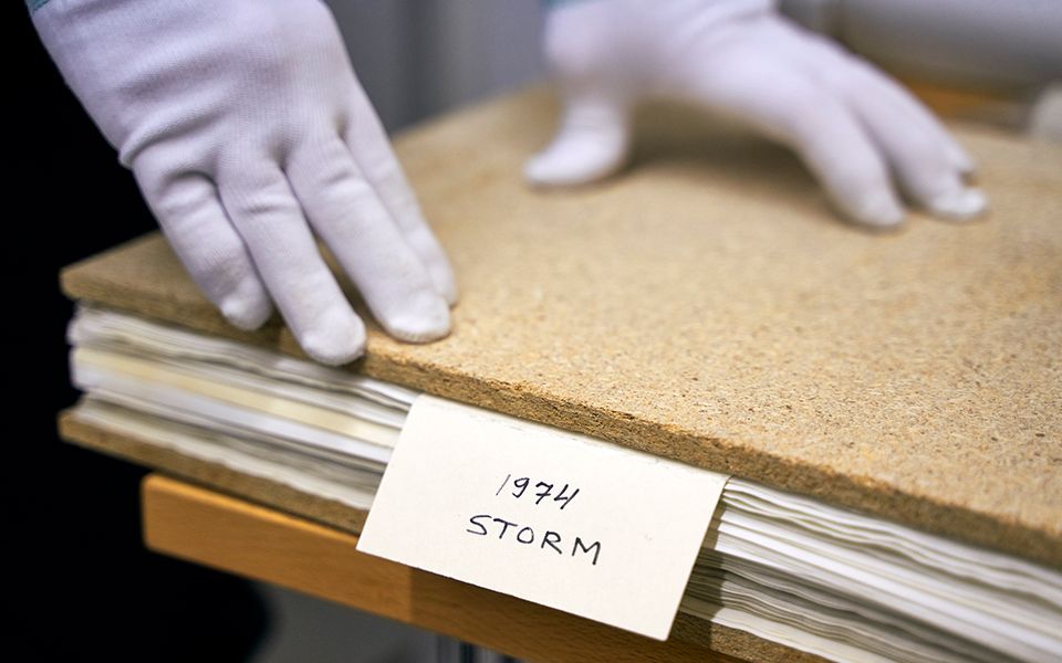 Road trip in Finland: Hunting northern lights with the Jaguar F-PACE Hands with white cloth gloves touching scientific record of Northern Lights Storm 1974