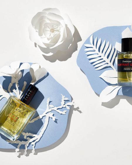 Still life with 2 fragrances, white paperart on blue paper