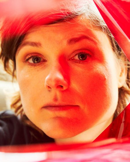 Tina Lorenz looks through red foil