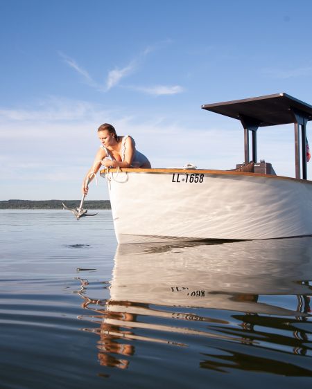 Young woman drops anchor in the water