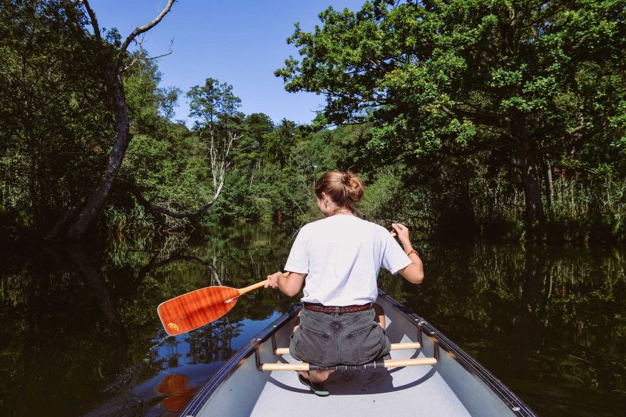Canoe Tour Lake Starnberg and Würm Young woman in canoe rowing
