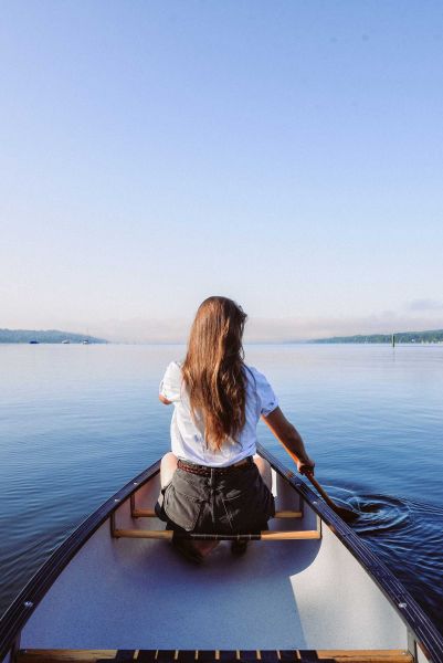 Canoe Tour Lake Starnberg and Würm Young woman in canoe rowing