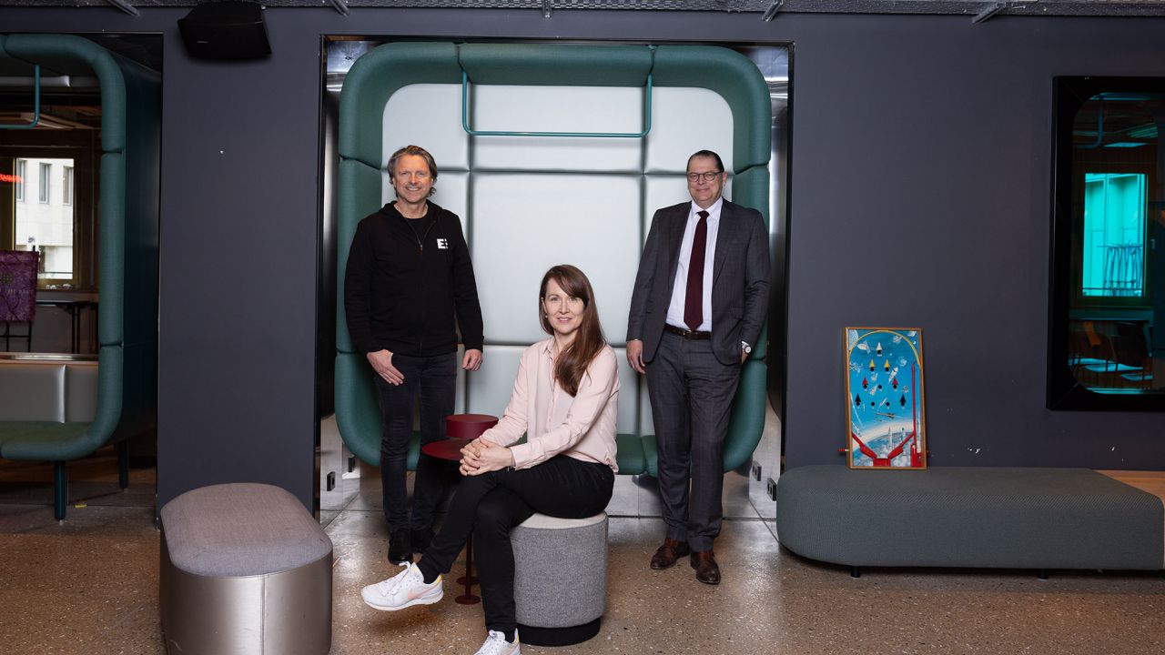 Two men and one woman in a modern office space Two men and one woman in a modern office space